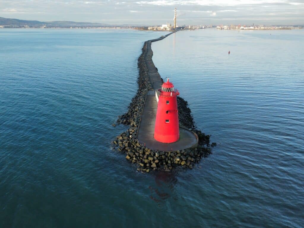 Dublin Bay seawall with calm waters and bright red lighthouse